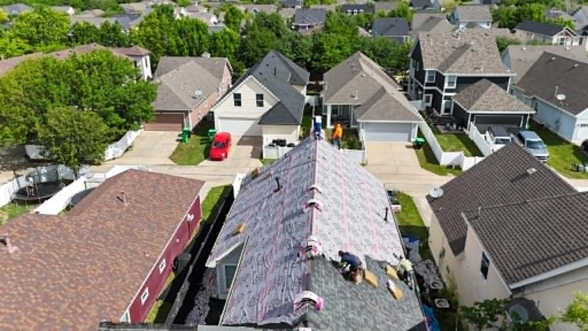 Crew installing new shingles
