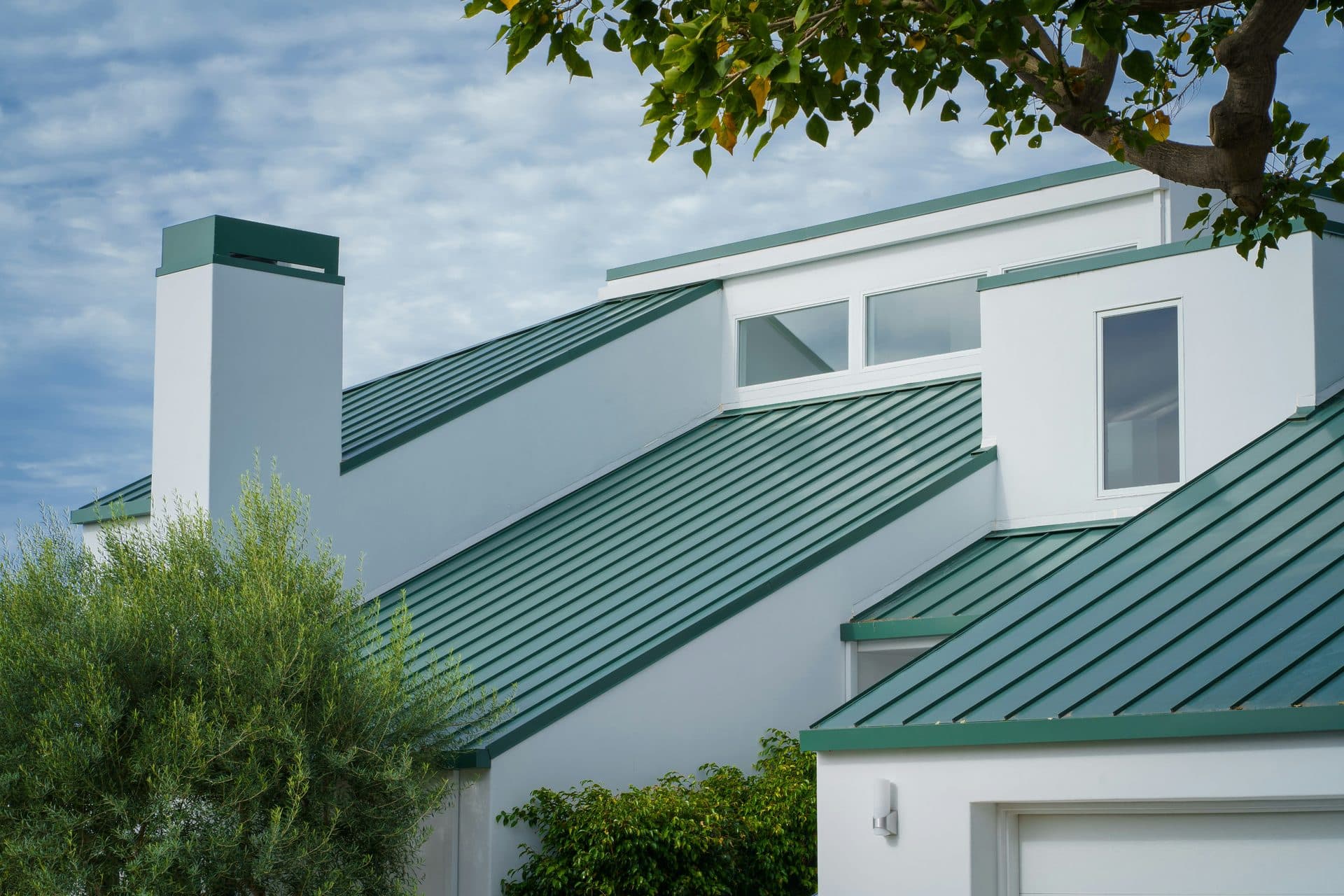 Home with a green standing seam metal roof